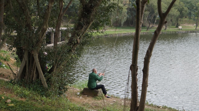 A man fishing on a lake.
