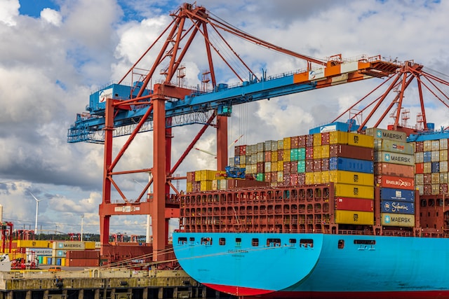 A container terminal with a crane over a container ship.